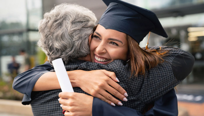 Graduate hugging her parent